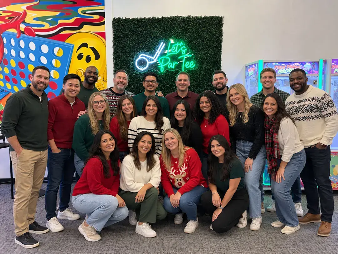Team posing at Mr. Putters indoor mini golf during a department offsite in Tampa, FL